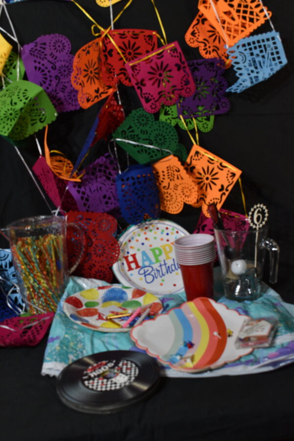 Bunting, sea scape plastic table cloth, jug of straws, party plates, cocktail sticks, plastic cups, place mats, cake candles & holders