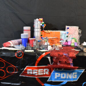 Plastic party cups (Red, Blue, clear), Paper streamers, Shot glasses, Placemats, Ribbons, Bunting, Beer pong mat, Red & white burger wraps, napkins, balloons, balloon weight, carrier bags, red table runner