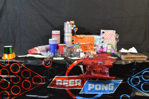 Plastic party cups (Red, Blue, clear), Paper streamers, Shot glasses, Placemats, Ribbons, Bunting, Beer pong mat, Red & white burger wraps, napkins, balloons, balloon weight, carrier bags, red table runner