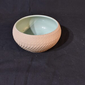 Brown pot with green interior